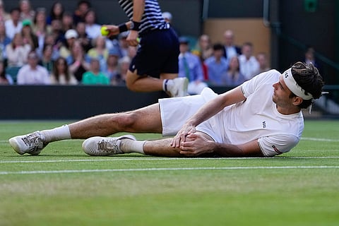 Taylor Fritz reacts after falling 